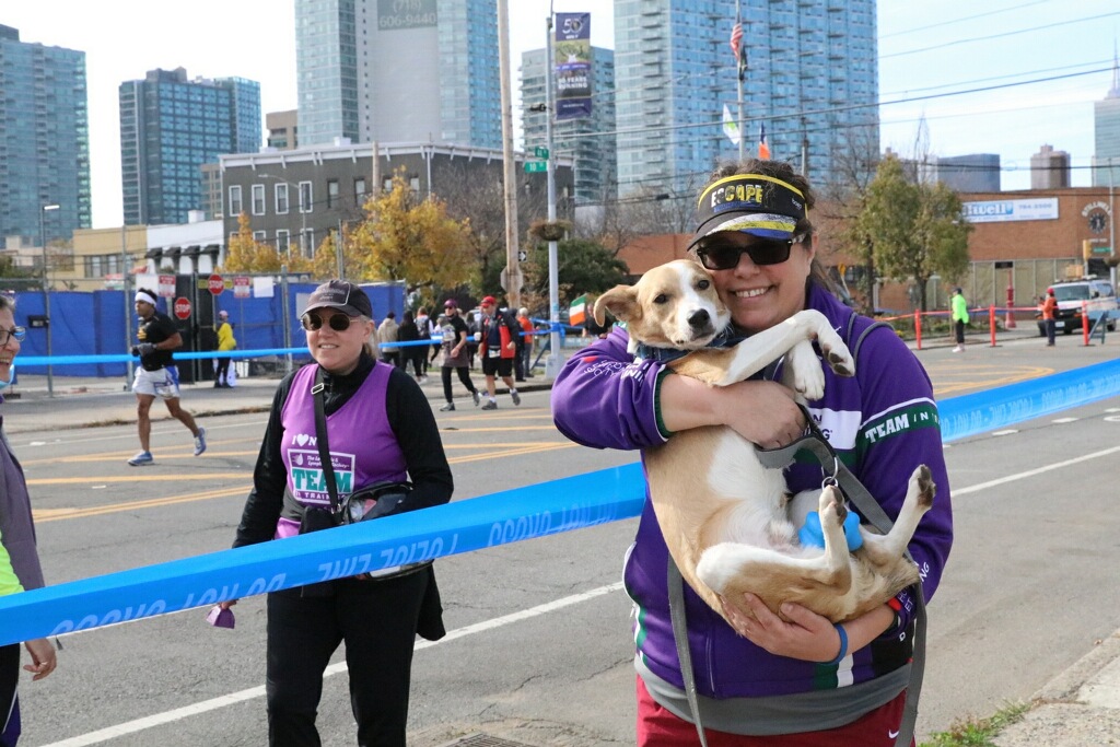 Carline and her dog, Dasher, cheering on runners at the NYC Marathon